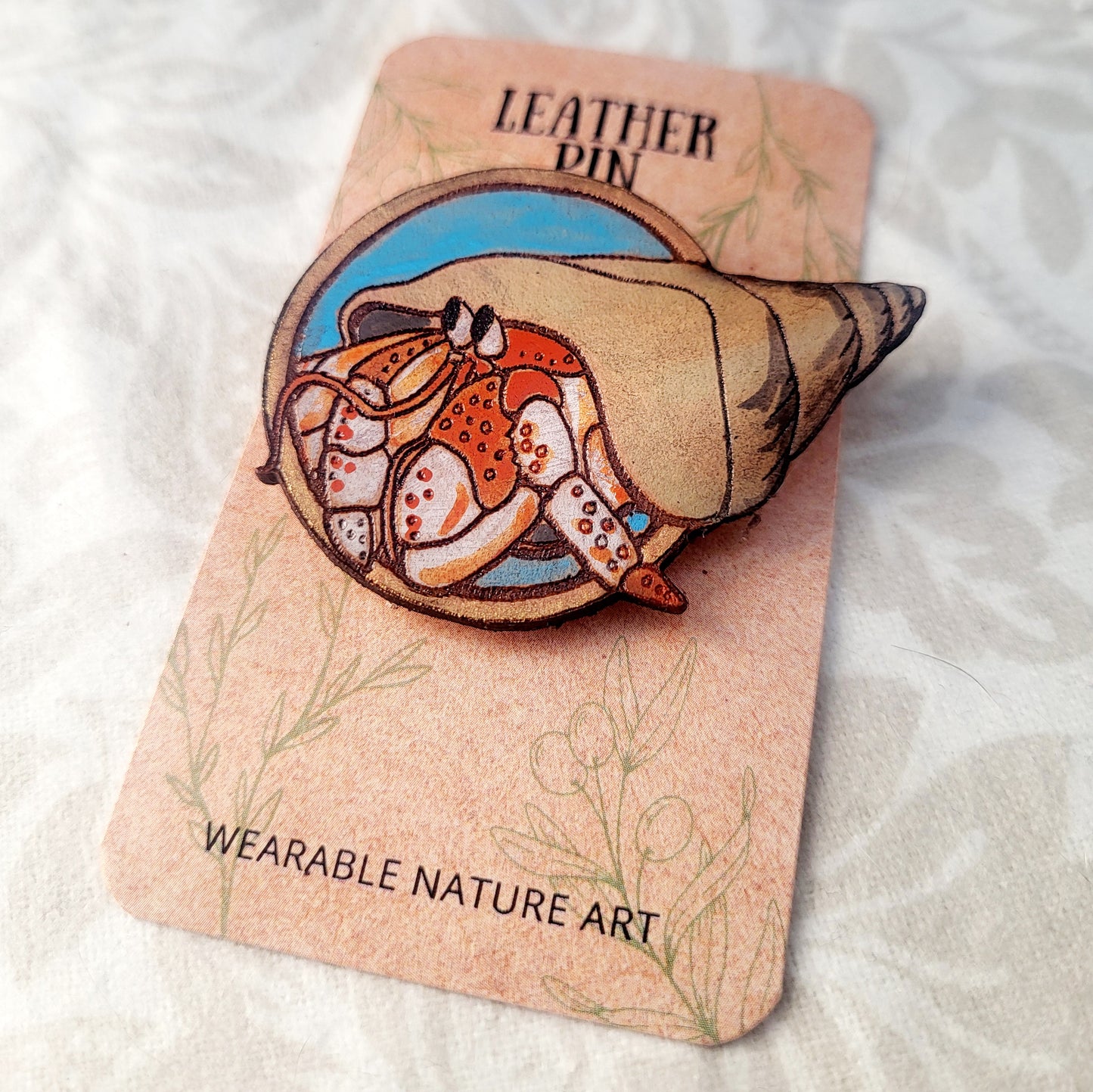 Hermit Crab on the Beach Leather Pin - July 2025 Limited Edition
