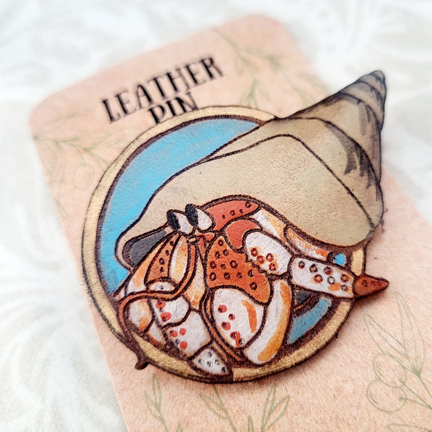 Hermit Crab on the Beach Leather Pin - July 2025 Limited Edition